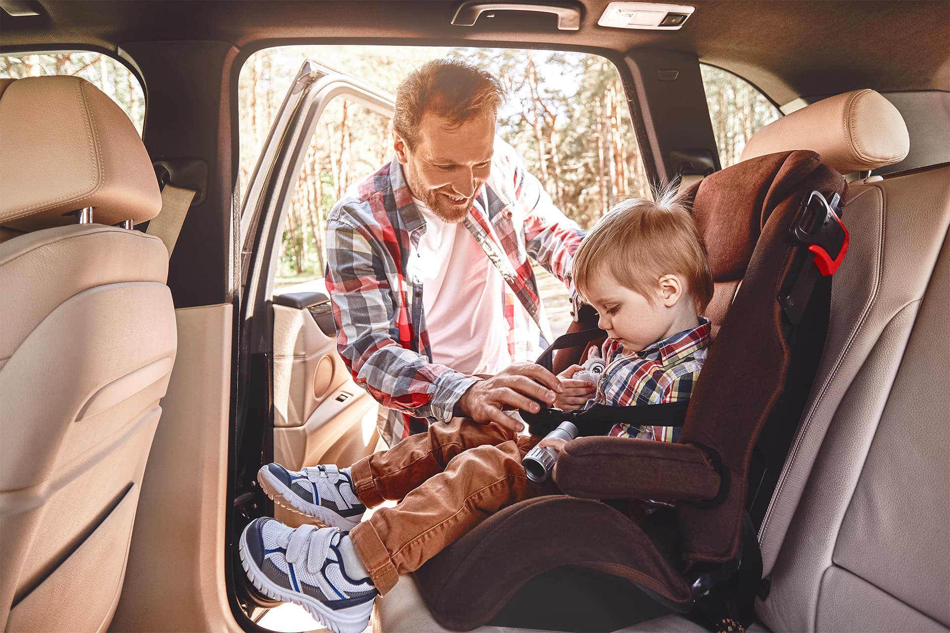 ATC driver assisting child into transport van